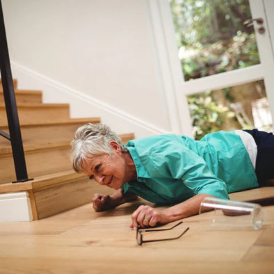An elderly woman on the floor after falling down stairs
