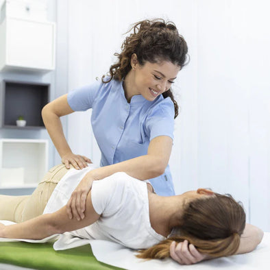 A physical therapist helping a patient's hip