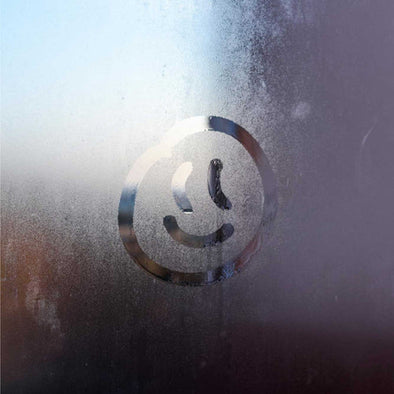 A smiley face written on a foggy window