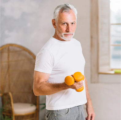 An elderly man holding dumbbells