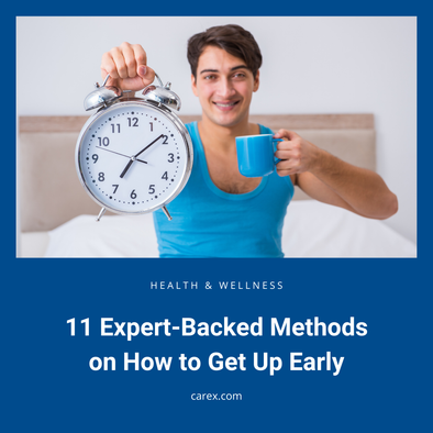 Smiling man holds an alarm clock and coffee mug, illustrating the best way to get up early