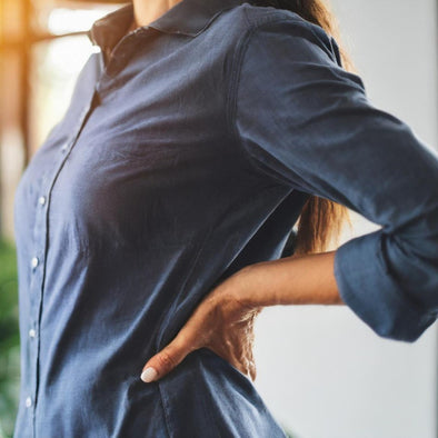 A woman holding her hip in pain