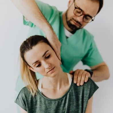 A doctor checking a woman's neck