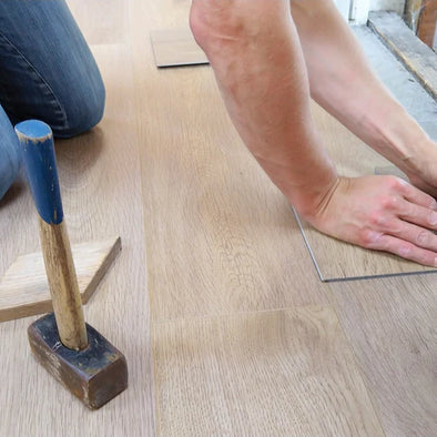 A man installing flooring