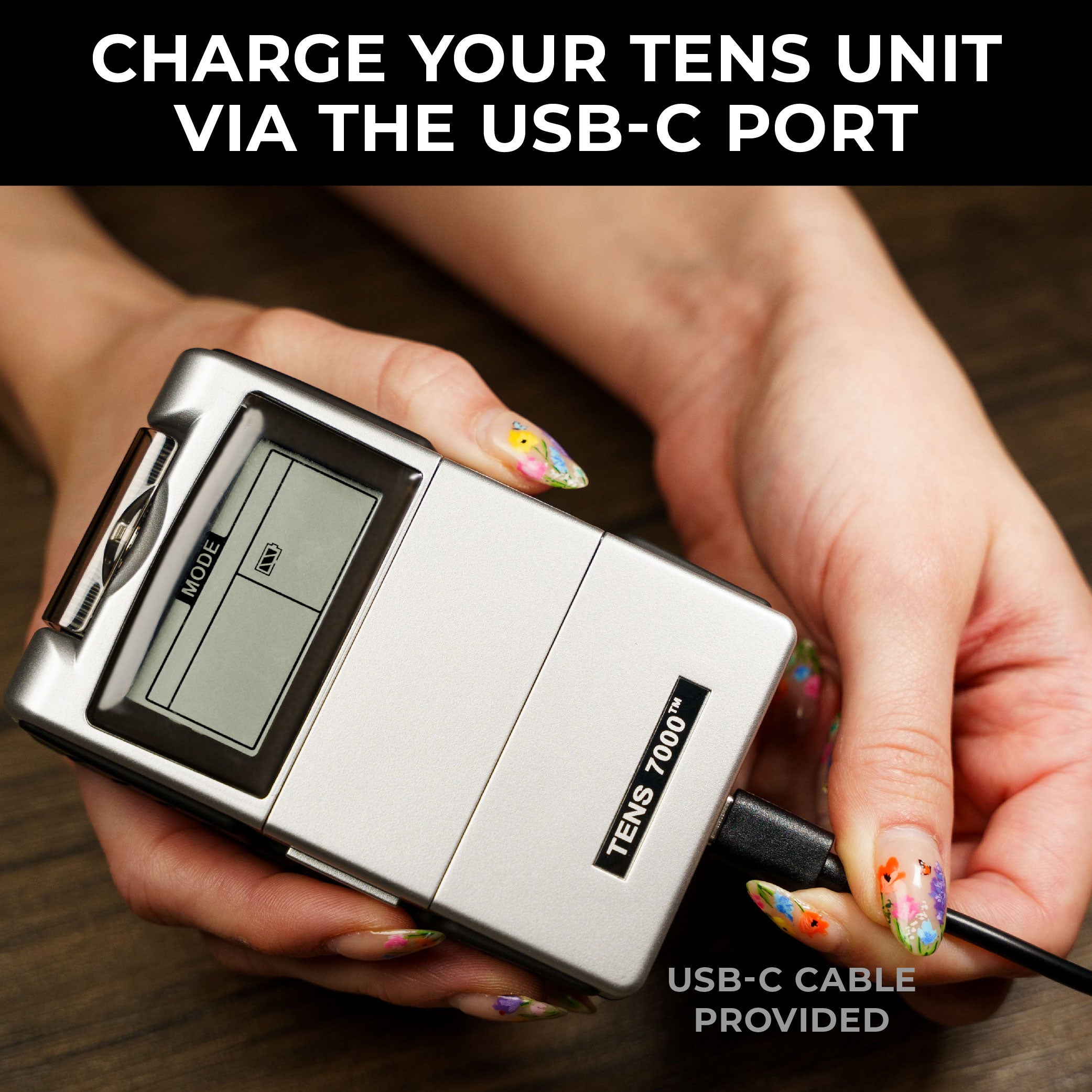 A TENS unit being charged. Text, 