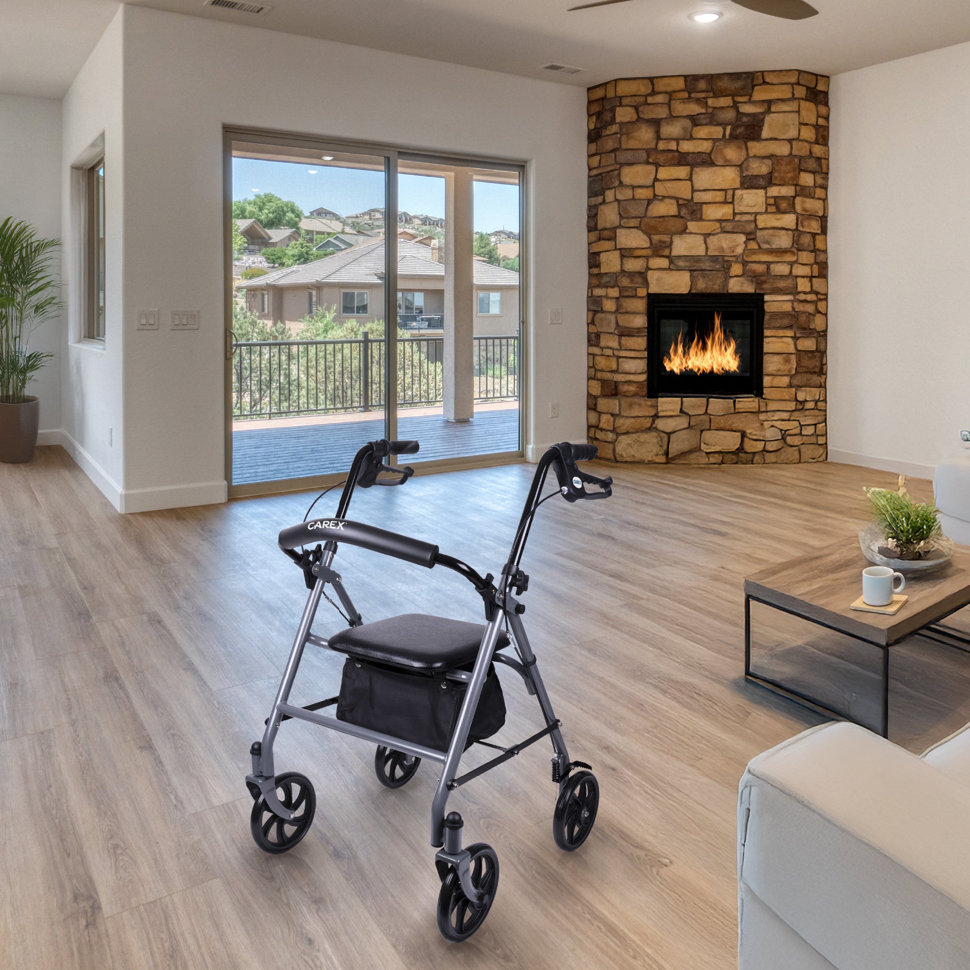 Rollator in a modern living room with a stone fireplace and large windows.