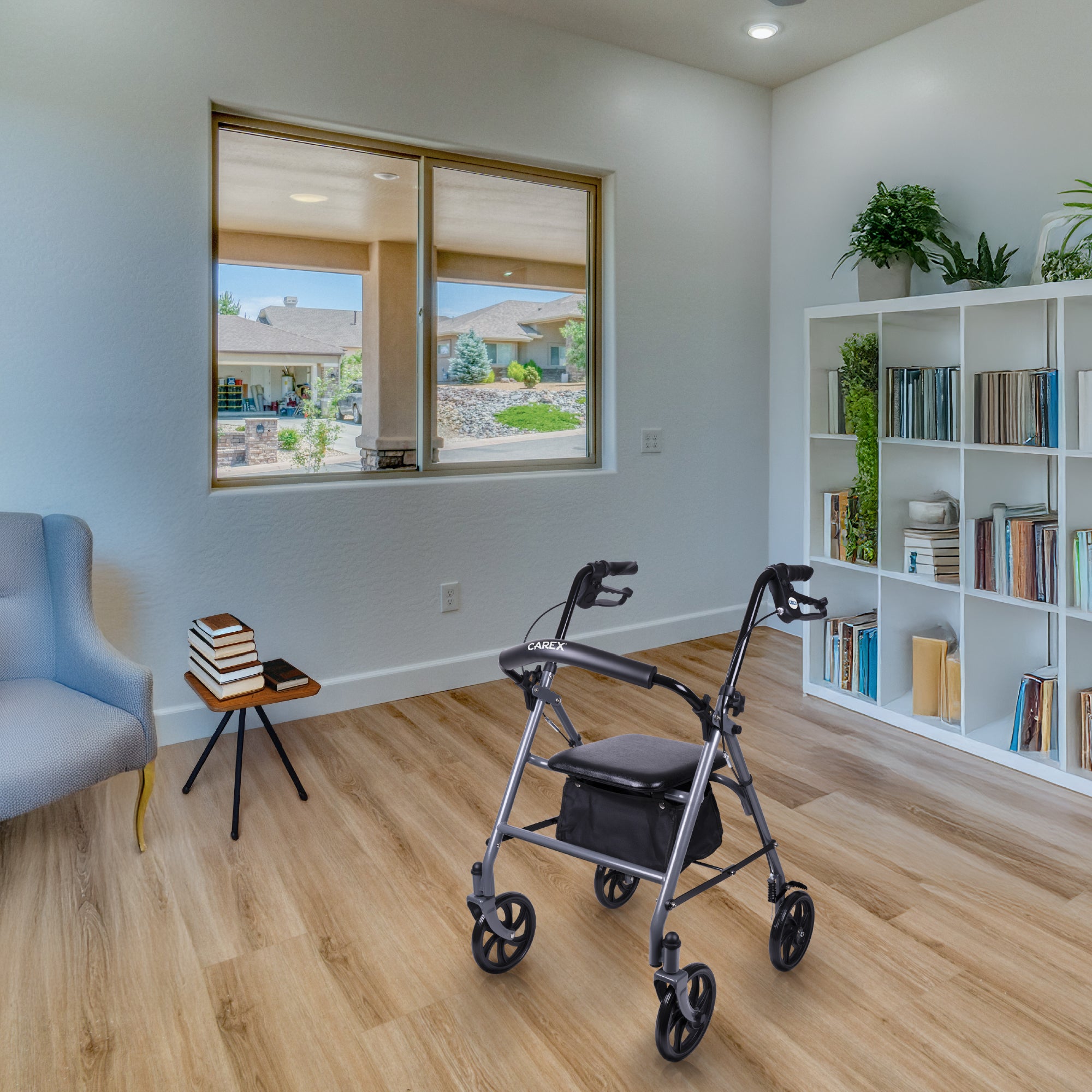 Living room with a rollator, bookshelf, and large window