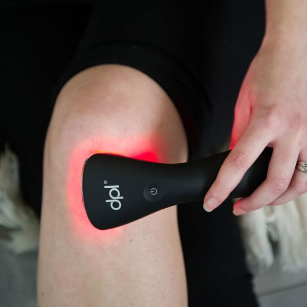 Red light therapy device for pain being used on a person's knee